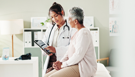 Female medical provider consulting with female patient